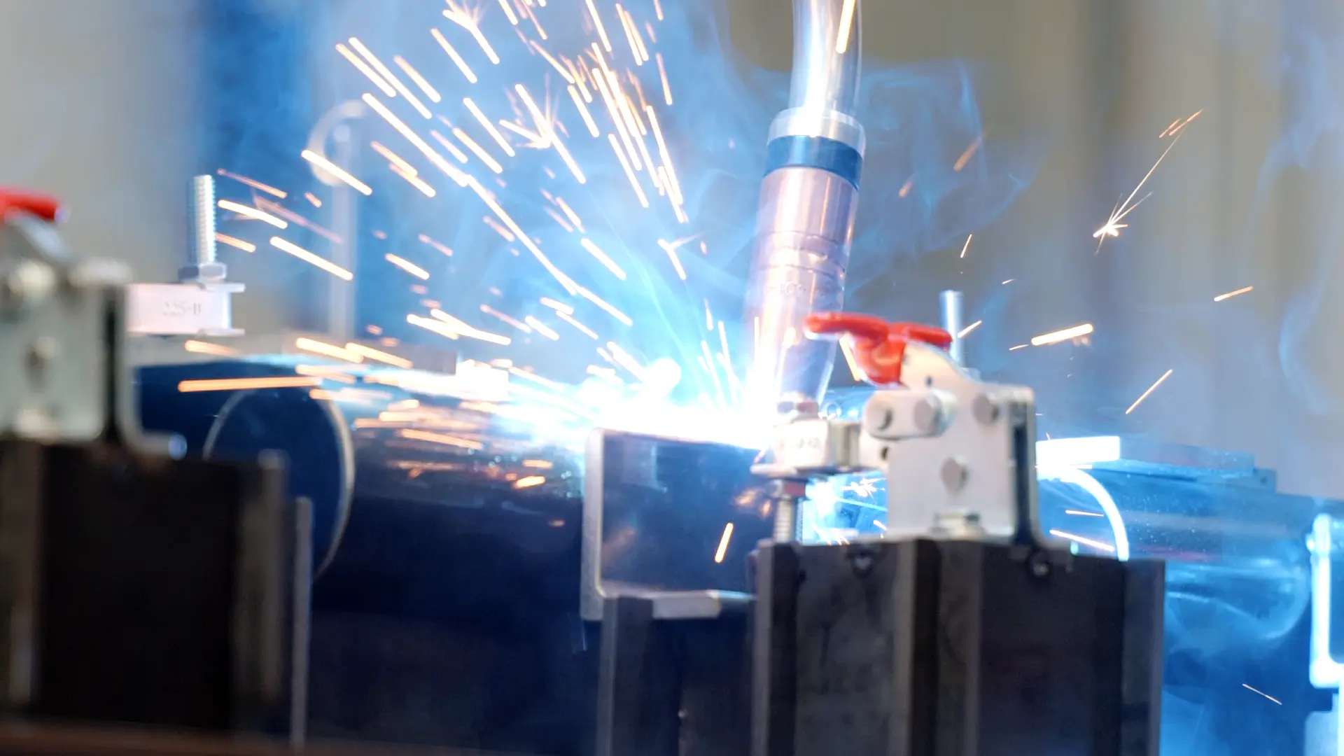 MIG welding a fabricated frame held in clamps on the Apopka floor