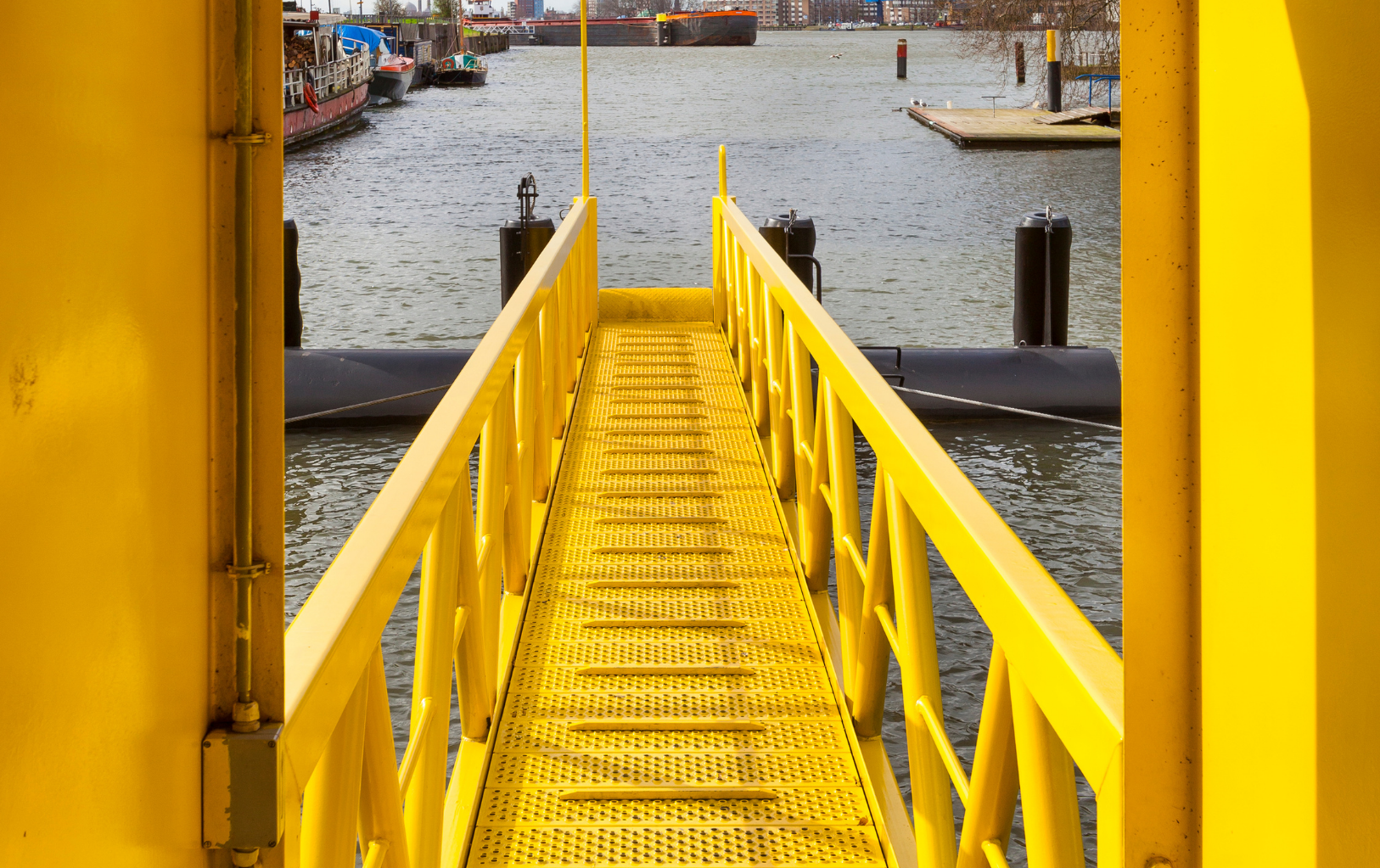 An assembled marine gangway — grating deck, stringers, stanchions and handrail working as one structure