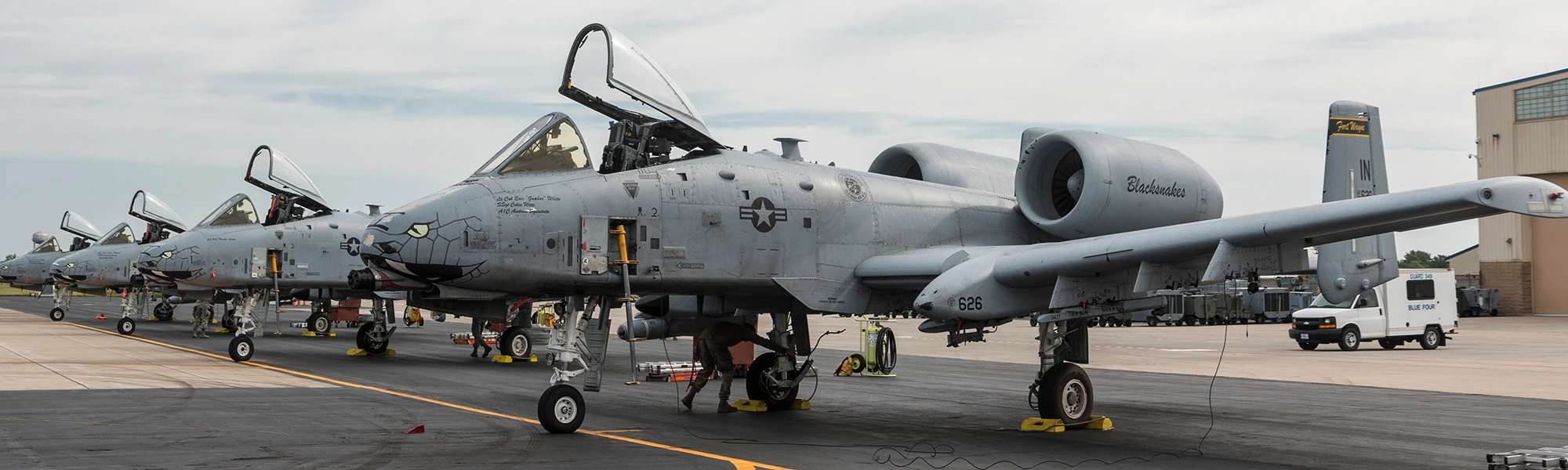 A-10 aircraft on the line with maintenance crews and ground equipment in position