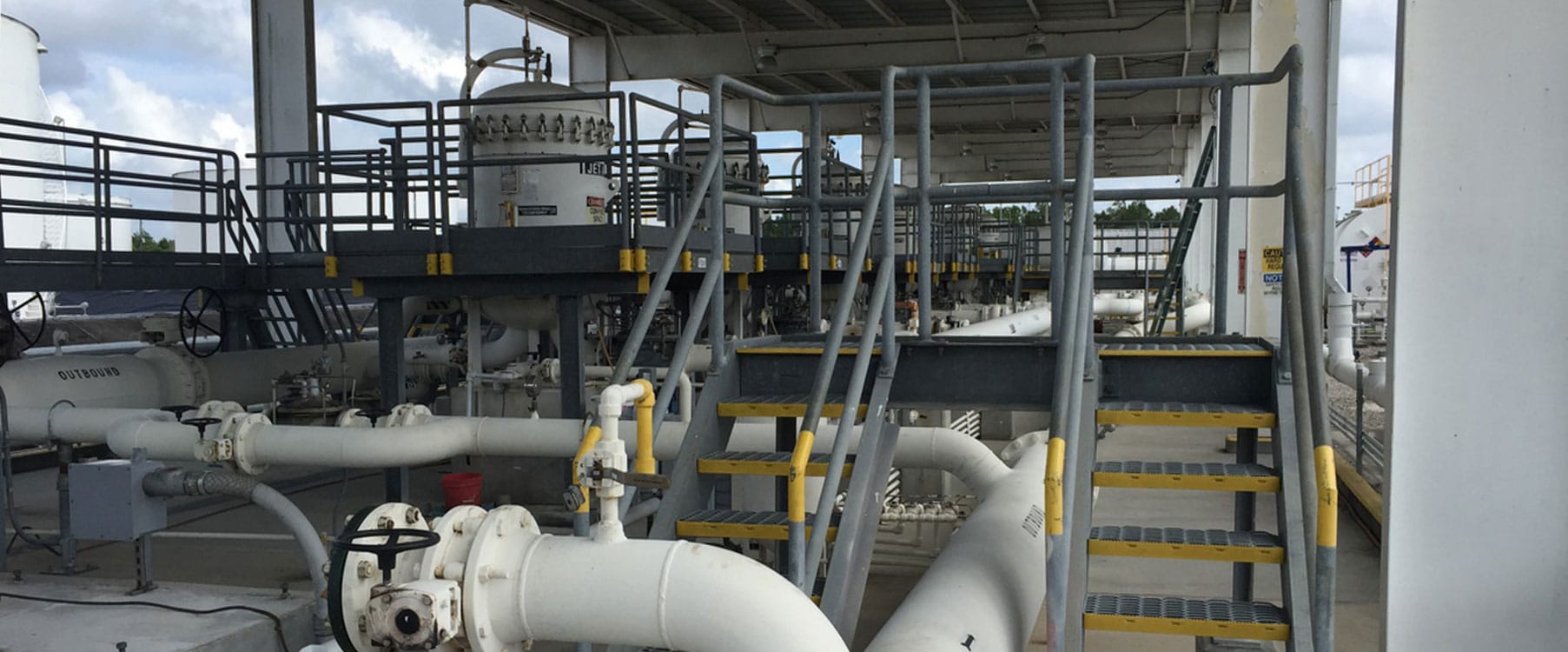 Access platform with guardrail threaded through existing terminal pipework
